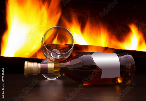 Bottle of brandy with the fireplace