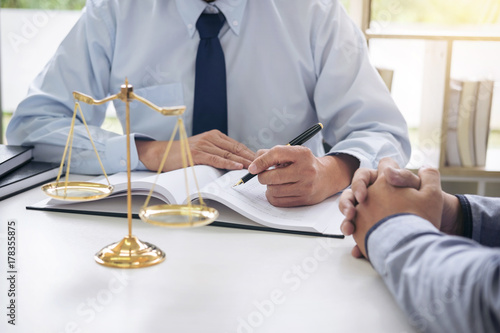 Judge gavel with scales of justice, Business people and male lawyers discussing contract papers at law firm in office. Concepts of law