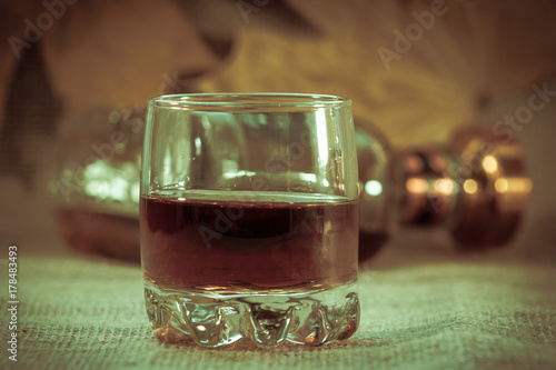 Two full stacks of whiskey without ice with almost empty bottle.