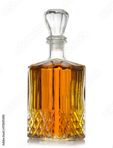 faceted bottle of cognac on white background