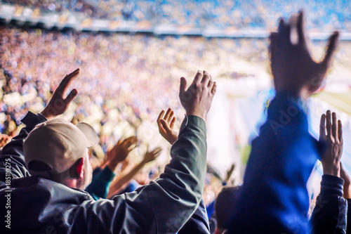Football fans clapping on the podium of the stadium © naftizin