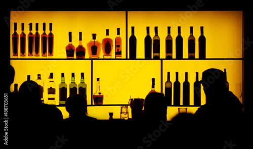 silhouette of people against of a bar
