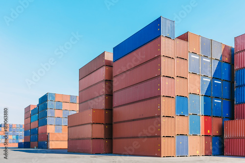Industrial port with containers box for logistic export import business with clear blue sky in background © interstid