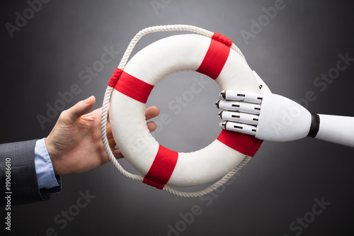 robot-giving-lifebelt-to-businessperson