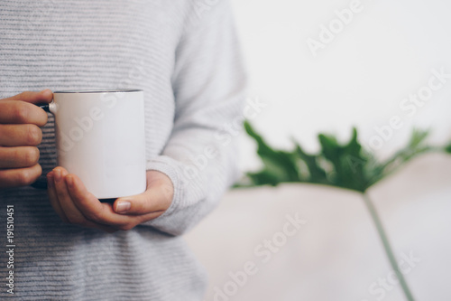 Hand holding coffee cup