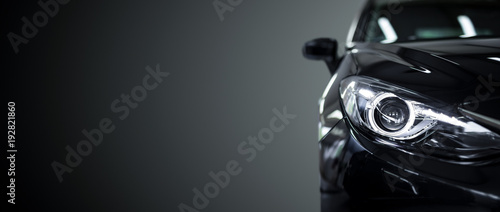 Black modern car on black background. © REDPIXEL
