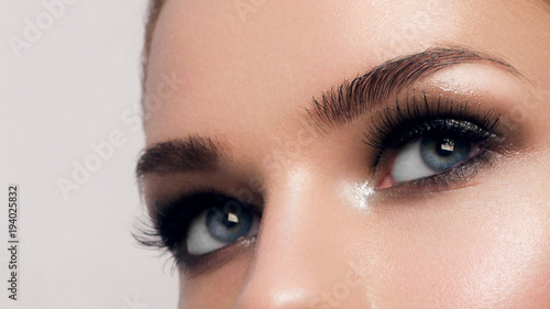 Macro shot of woman's beautiful eye with extremely long eyelashes. Sexy view, sensual look. Female eye with long eyelashes © evgeniyasht19