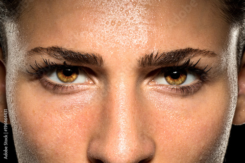 Expressive female eyes during fitness exercise workout showing endurance, stamina, confidence, and power