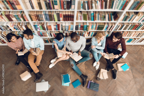 Top view group of ethnic multicultural students in library.