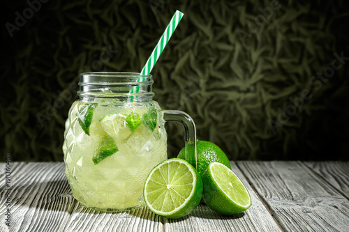 Lemonade in a glass jar with slice of lime © i_arnaudov