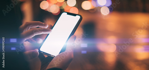 Close up image of man's hands with smartphone