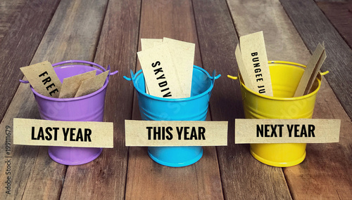 Conceptual and inspirational resolution wordings - ‘Last year, this year and next year’ written on sticky notes. With vintage styled background.