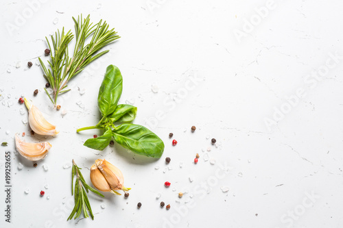 Spices and herbs over white stone table top view. © nadianb