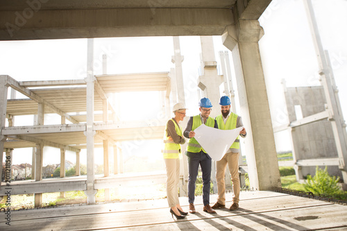 sunset on the construction site and satisfied team.