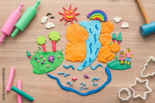 Kid's playing and creating toys from play dough and Molding clay. © graphixchon