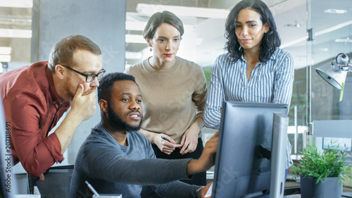 In Busy Corporate Office Team of Diverse Young Creative People Work on a Problem Solution. Collectively They Try to Help Coworker to Solve Problem.