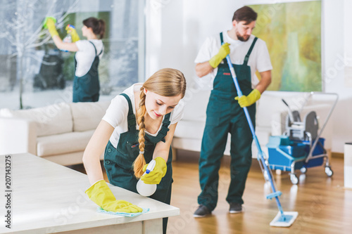 Cleaning service employees with professional equipment cleaning a private home after renovation © Photographee.eu