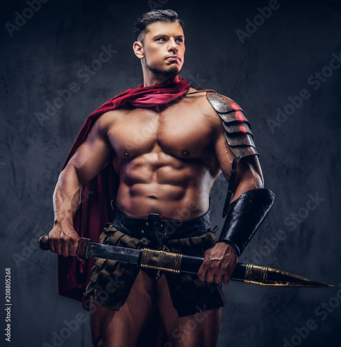 Brutal ancient Greece warrior with a muscular body in battle uniforms
