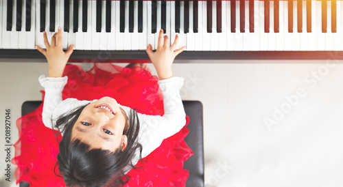 Little asian girl happy to play piano © joey333