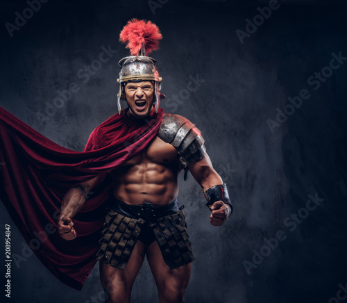 Brutal ancient Greece warrior with a muscular body in battle uniforms screams in battle agony