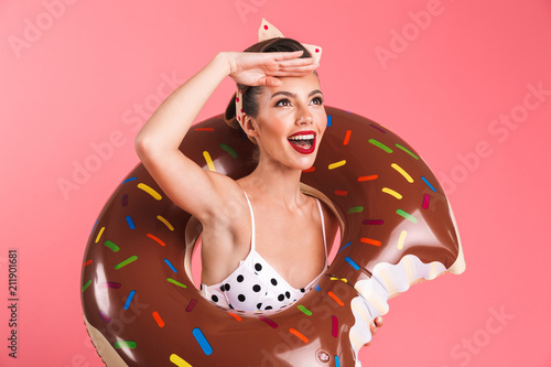 Gorgeous young pin-up woman in swimwear with inflatable ring. Looking aside. © Drobot Dean
