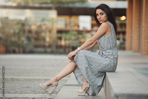 Woman fashion model posing sitting in city © antgor