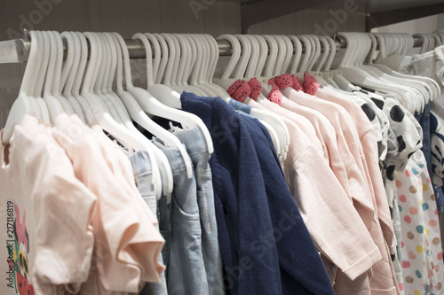 Photos of hangers with different fashionable clothes in the Department