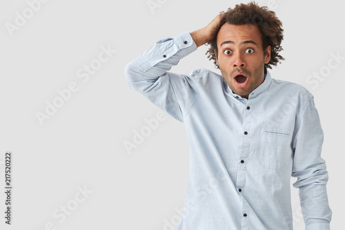 Terrified Mixed Race Male With Crisp Hair Opens Mouth Widely Has