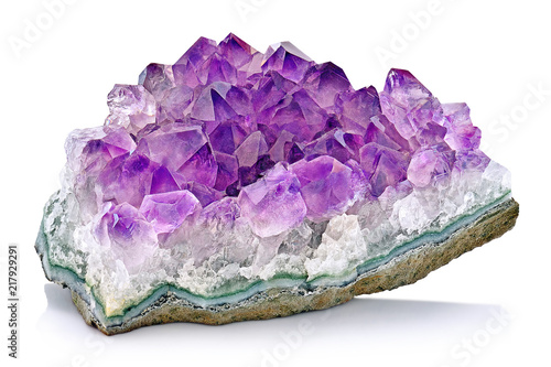 Violet Crystal Stone macro mineral. Purple rough Amethyst quartz crystals geode on white background, Uruguay © Sebastian