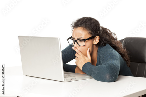 Young African Tired And Sleepy Woman Sitting At Her Desk In Front