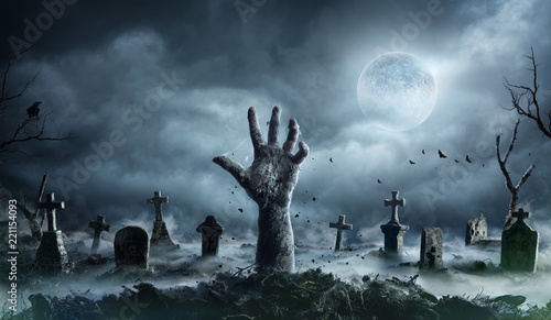 Zombie Hand Rising Out Of A Graveyard In Spooky Night