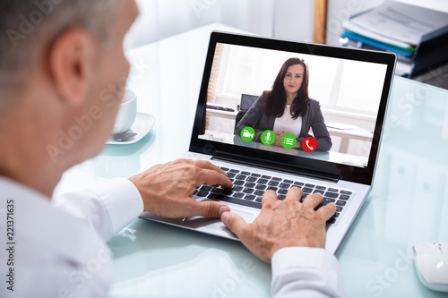 Businessman Videoconferencing With Colleague On Laptop © Andrey Popov