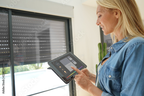 Woman at home using smart screen, automation domestic system © goodluz
