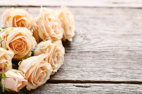 Bouquet of beige roses on grey wooden table © 5second