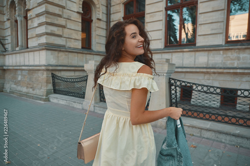 Portrait of stylish smiling, happy brunette woman walking on the © diignat
