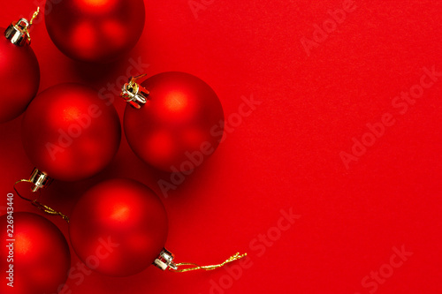 Christmas tree decoration balls on red background with copy space © Ruslan Grumble