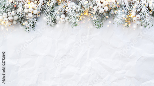 Christmas and New Year holiday background. Xmas greeting card. Spruce tree on white creased background. © elenabdesign