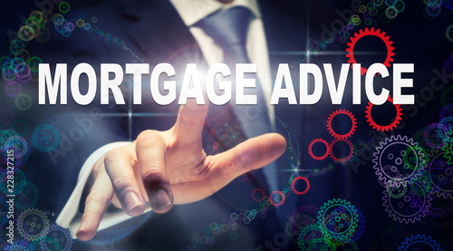 A businessman pressing a Mortgage Advice business concept on a graphical display of cogs