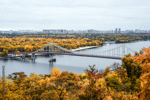 Golden autumn in Kiev, Ukraine. View on footbridge, river Dnieper and Trukhanov Island in Kyiv. © esvetleishaya