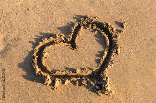 Heart shape on the sand at the sea beach. © igorkol_ter