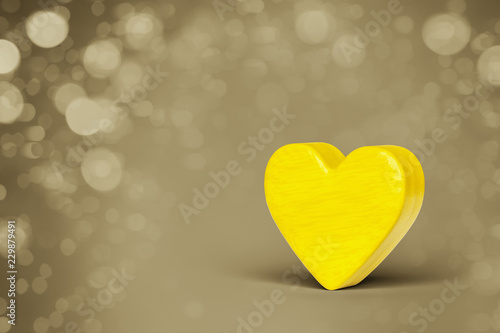 A yellow wooden heart in a bokeh lights background © magann