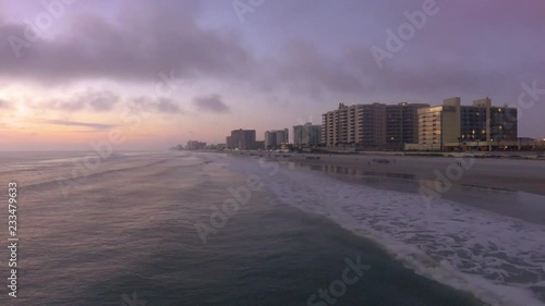 This is a beautiful sunrise drone shot of the Ocean at Daytona Beach in Florida. © blackboxguild