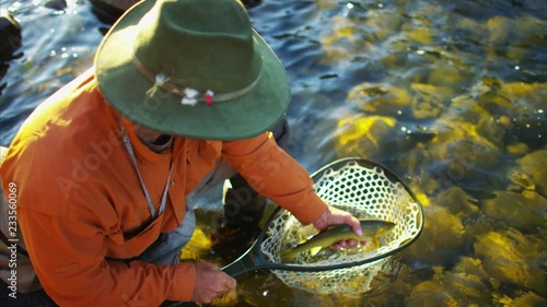 Fisherman with catch in keep net freshwater river USA © Spotmatik
