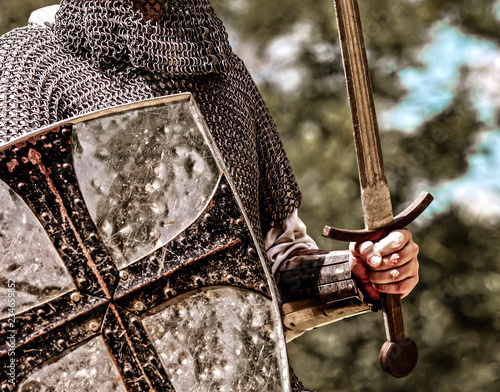 Closeup view on traditional medieval knight with shield and sword.