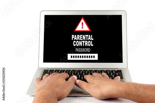 Technology child protection concept: man using a laptop with parental control on the laptop screen © tuahlensa