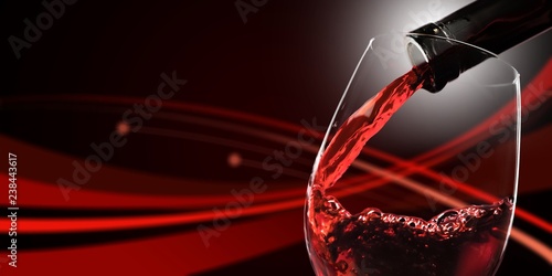 Red wine pouring in glass on  background
