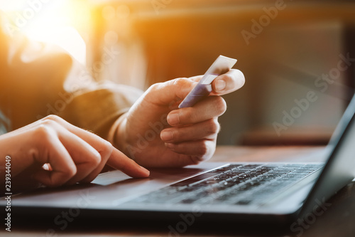 Online payment,Man's hands holding credit card and using laptop computer for online shopping. Cyber Monday Concept