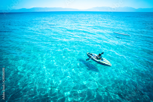 View From Lake Tahoe With Tropical Blue Color Water And Canoe View From Lake Tahoe With Tropical Blue Color Water And Canoe