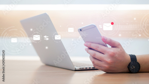 close up businessman holding smartphone and checking email online on web with virtual interface technology concept