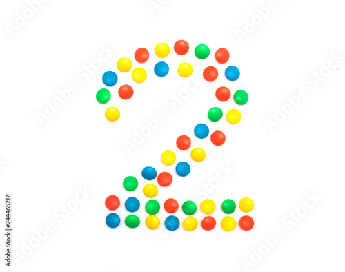 Children's numbers laid out from a multi-colored mosaic figure number 2, alphabet